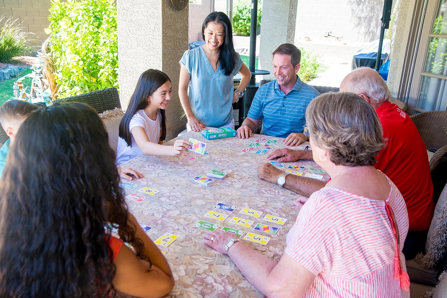Family playing Skyjo around a table